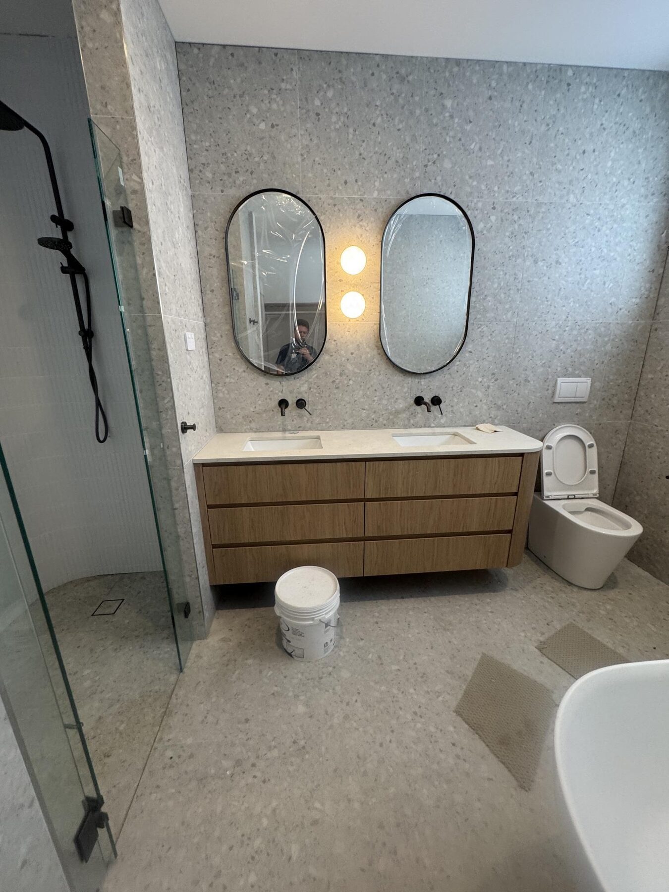 Finished bathroom renovation with double vanity, wall-mounted tapware and in-wall cistern toilet