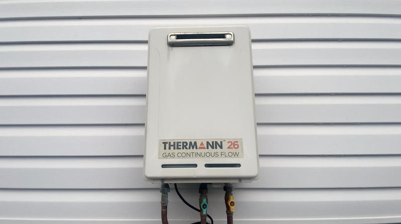 Thermann gas continuous flow hot water unit mounted on an exterior wall