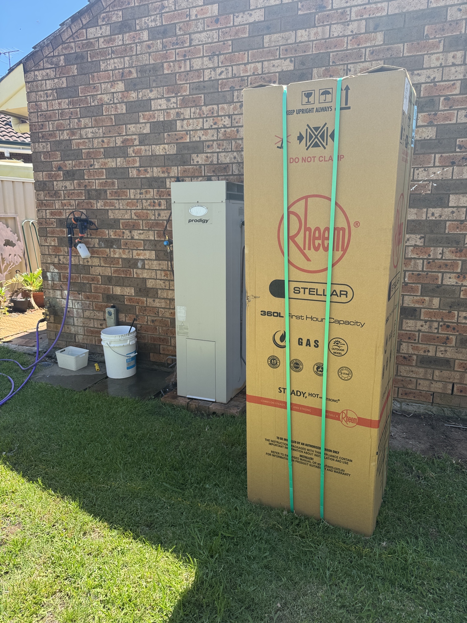Old Dux hot water heater next to new Rheem Stellar gas storage hot water heater upgrade in St Helens Park